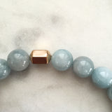 Men's light blue aquamarine beaded energy bracelet close up on gold hexagon bead