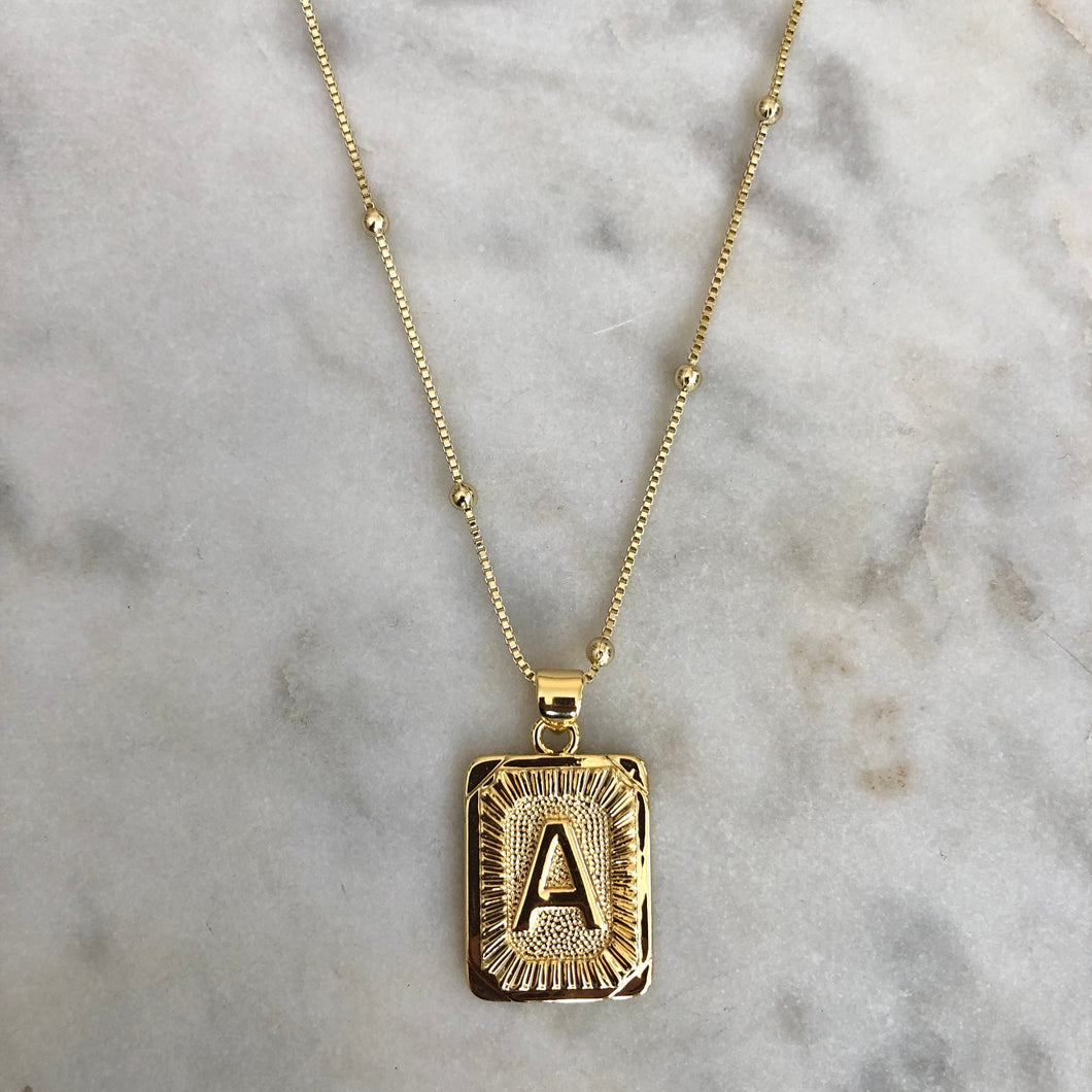 Gold initial necklace on delicate satellite chain
