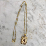 Gold initial necklace on delicate satellite chain